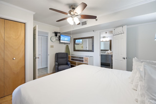 24230 Perdido Beach Blvd Unit 3087, Orange Beach, AL 36561 - bedroom with connected bathroom, ceiling fan, two closets, and ornamental molding
