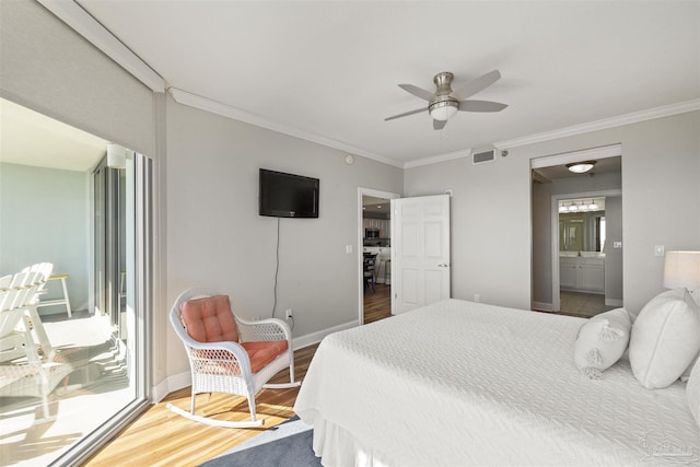 bedroom featuring ceiling fan, multiple windows, hardwood / wood-style flooring, and ornamental molding