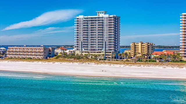 birds eye view of property featuring a beach view and a water view