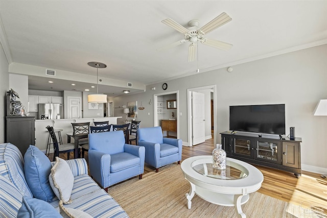 living room with ceiling fan and light wood-type flooring