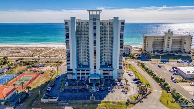 drone / aerial view with a beach view and a water view