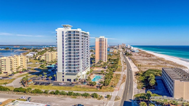 bird's eye view featuring a water view and a beach view