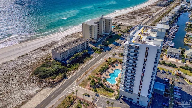 birds eye view of property featuring a beach view and a water view