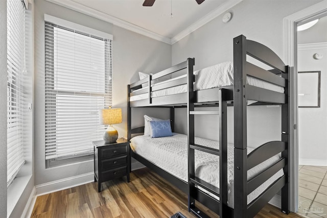 bedroom with ceiling fan, dark hardwood / wood-style floors, and crown molding