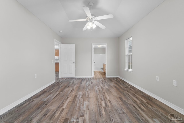 unfurnished bedroom featuring ceiling fan and dark hardwood / wood-style floors