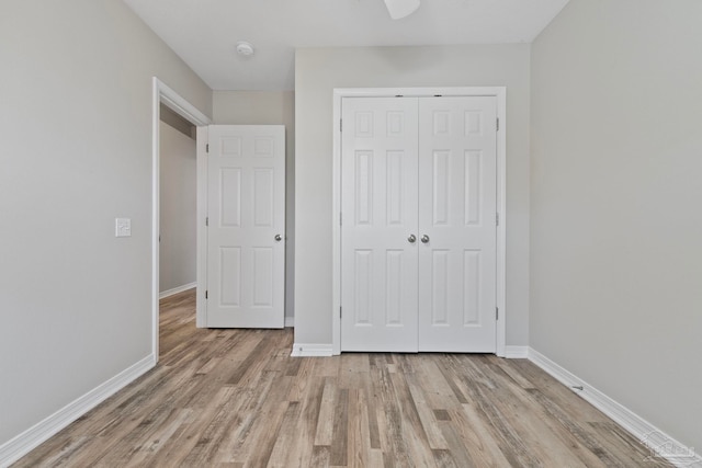 unfurnished bedroom with light hardwood / wood-style floors and a closet