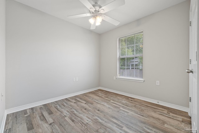 spare room with ceiling fan and light wood-type flooring