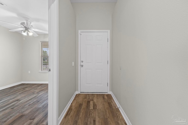 corridor featuring vaulted ceiling and dark wood-type flooring