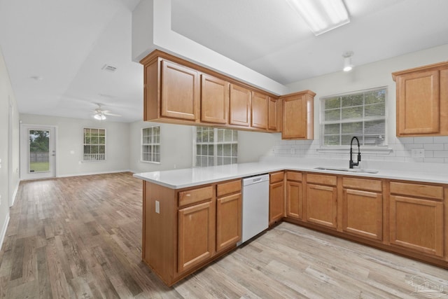 kitchen featuring dishwasher, light hardwood / wood-style floors, sink, and kitchen peninsula