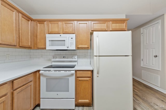 kitchen featuring decorative backsplash, white appliances, and light hardwood / wood-style flooring