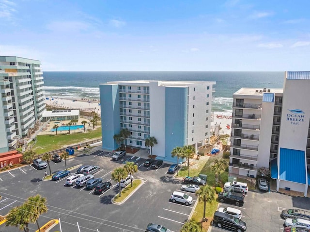 view of property with a water view and uncovered parking