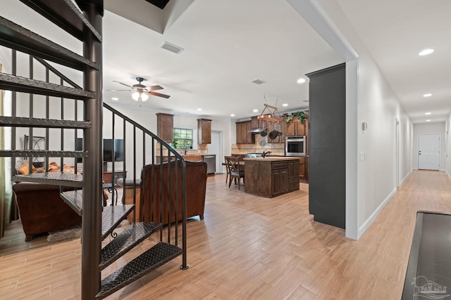 6781 Generals Ln, Pace, FL 32571 - stairs featuring recessed lighting, wood finished floors, and ceiling fan