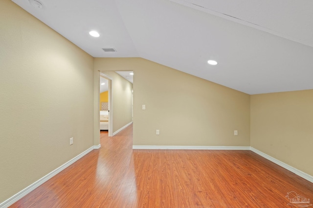 6781 Generals Ln, Pace, FL 32571 - spare room with light wood-type flooring, vaulted ceiling, a smoke detector, and recessed lighting