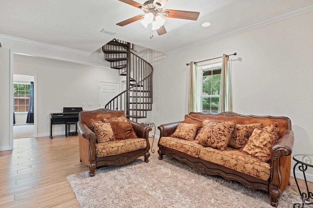 6781 Generals Ln, Pace, FL 32571 - living area featuring light wood finished floors, stairway, crown molding, and a ceiling fan
