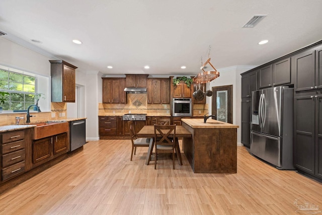 6781 Generals Ln, Pace, FL 32571 - kitchen featuring appliances with stainless steel finishes, crown molding, tasteful backsplash, an island with sink, and recessed lighting
