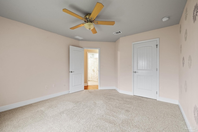 unfurnished bedroom featuring light carpet, baseboards, and ceiling fan