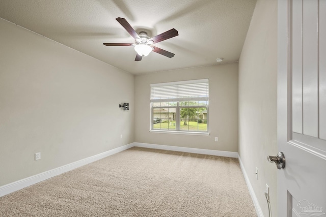 spare room featuring a ceiling fan, a textured ceiling, carpet flooring, and baseboards