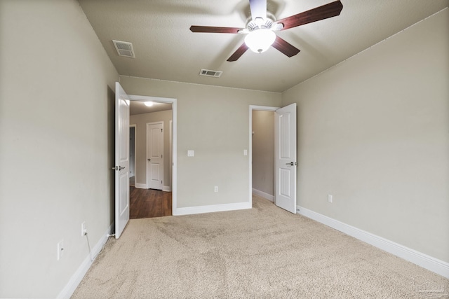 unfurnished bedroom with carpet floors, baseboards, and a ceiling fan