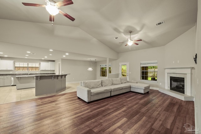 living room with ceiling fan, wood-type flooring, healthy amount of natural light, recessed lighting, and high vaulted ceiling