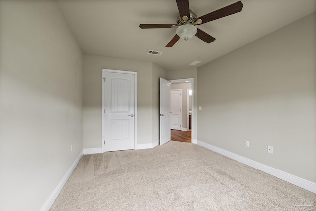 unfurnished bedroom with carpet floors, baseboards, and a ceiling fan
