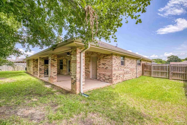 view of property exterior featuring brick siding and a patio area