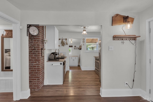 407 Rue Max St, Pensacola, FL 32507 - kitchen with dark wood-type flooring, white cabinetry, baseboards, and stainless steel electric range oven