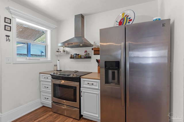 407 Rue Max St, Pensacola, FL 32507 - kitchen featuring appliances with stainless steel finishes, ventilation hood, dark wood-style flooring, white cabinetry, and baseboards