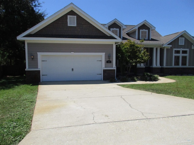 craftsman-style home featuring driveway, a garage, and a front lawn