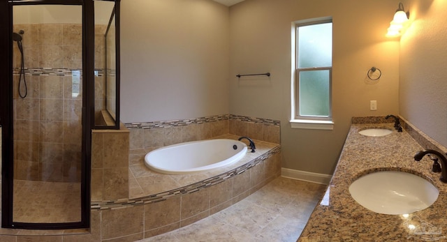 bathroom with double vanity, a sink, a stall shower, and a bath