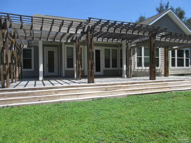 rear view of house with a lawn and a pergola