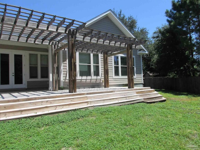 exterior space featuring a pergola, a lawn, fence, and french doors
