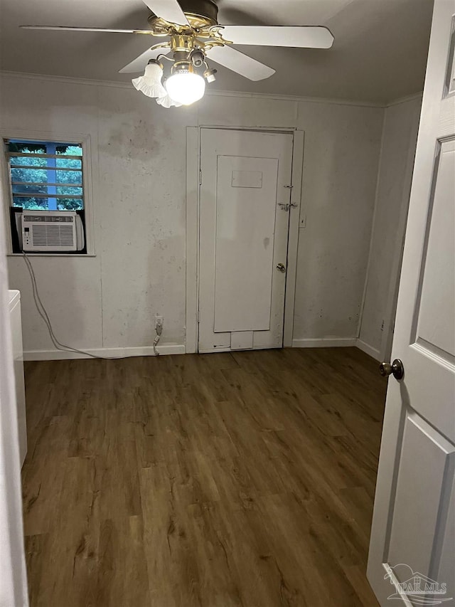 interior space with wood-type flooring, cooling unit, and ceiling fan