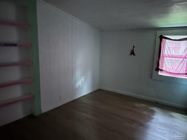 spare room featuring dark wood-type flooring