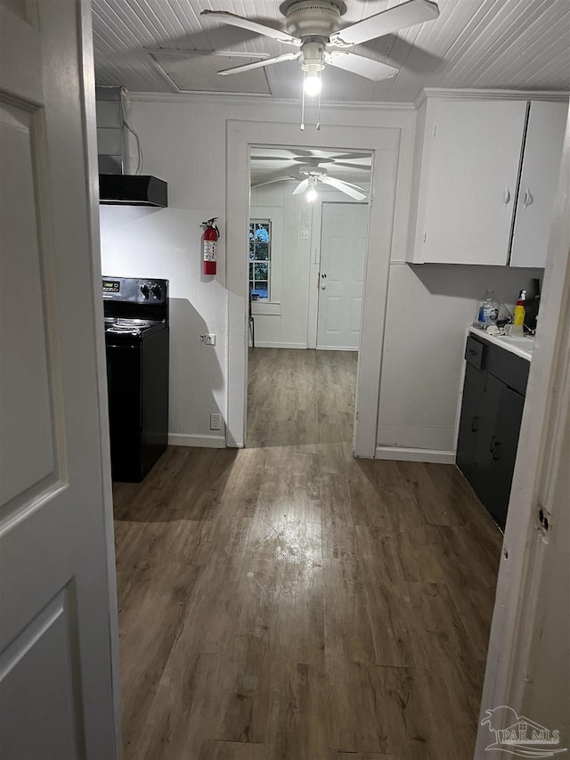 kitchen featuring extractor fan, black electric range oven, white cabinets, dark hardwood / wood-style flooring, and ceiling fan