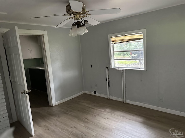 empty room featuring crown molding, ceiling fan, and hardwood / wood-style floors