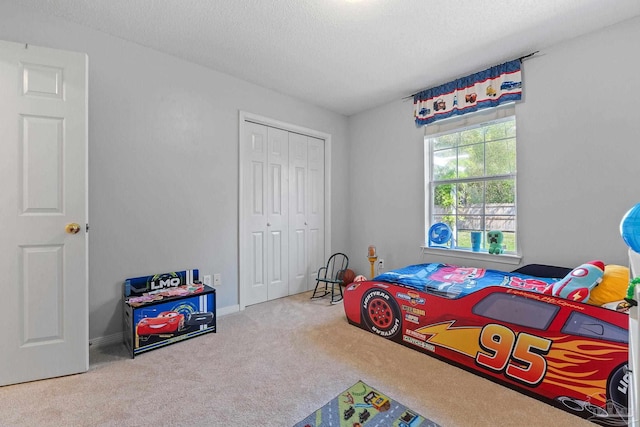 544 Batten Blvd, Pensacola, FL 32507 - bedroom featuring a textured ceiling, a closet, and carpet