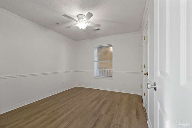 spare room with ceiling fan, wood-type flooring, crown molding, and a textured ceiling