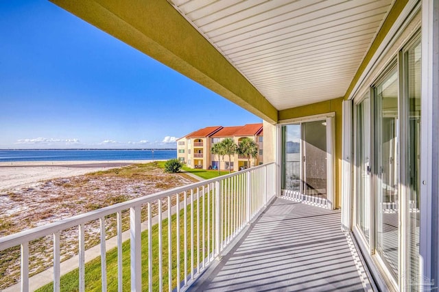 balcony with a beach view and a water view