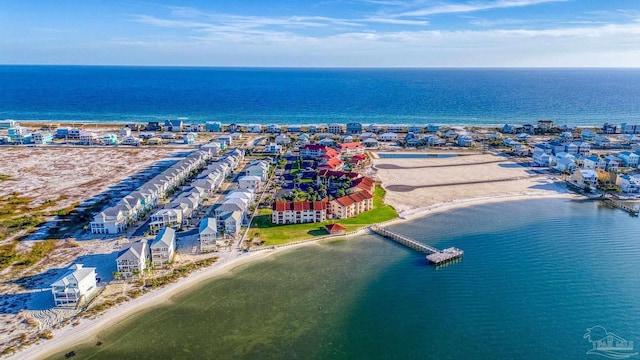 birds eye view of property with a water view and a view of the beach