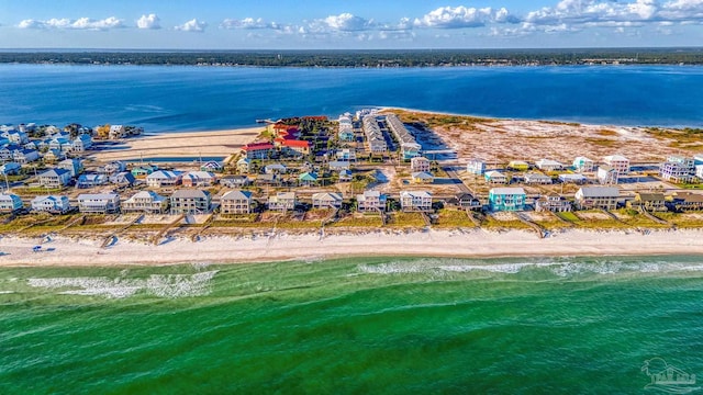 bird's eye view with a water view and a beach view