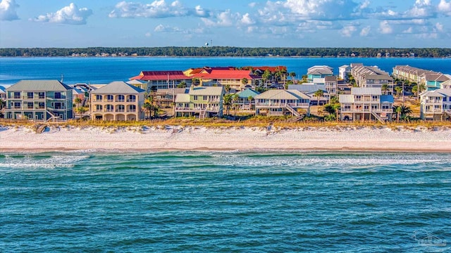 exterior space featuring a beach view and a water view