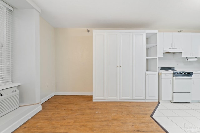 kitchen with light hardwood / wood-style flooring, white range oven, and white cabinets