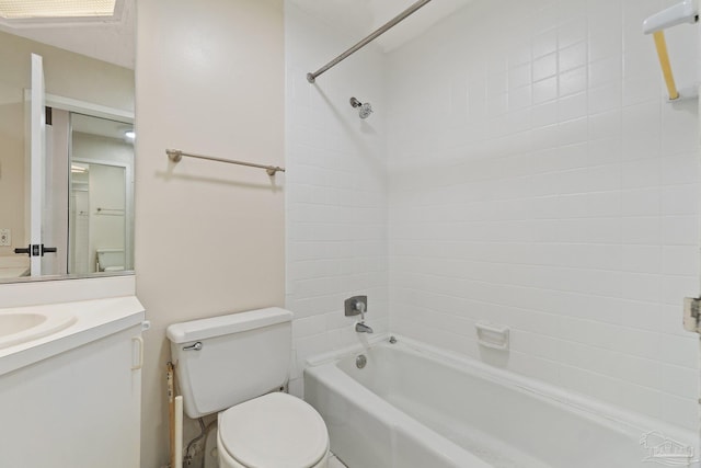 full bathroom featuring toilet, tiled shower / bath combo, and vanity