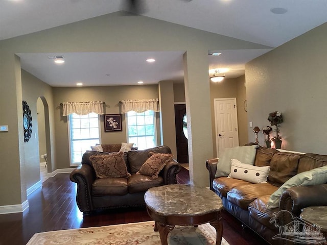 living area featuring arched walkways, recessed lighting, dark wood-style flooring, baseboards, and vaulted ceiling