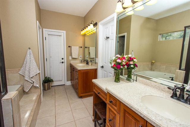 full bathroom featuring a garden tub, two vanities, a sink, and tile patterned flooring