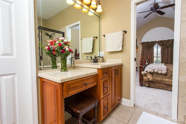 ensuite bathroom featuring a ceiling fan, lofted ceiling, ensuite bath, tile patterned flooring, and vanity