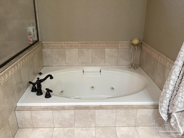 bathroom with a tub with jets