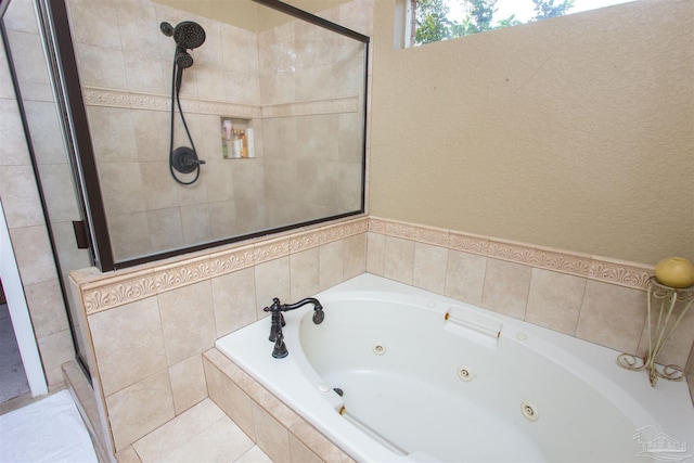 bathroom featuring a jetted tub and a shower stall