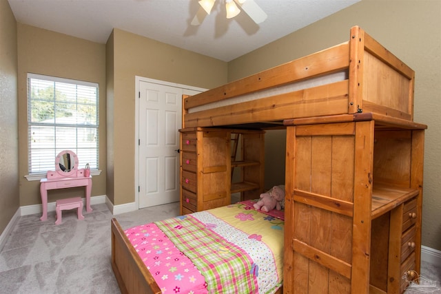 bedroom with light colored carpet and baseboards