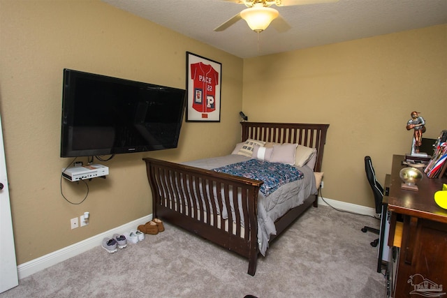 bedroom featuring light carpet, ceiling fan, and baseboards